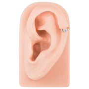 14k gold CZ clicker cartilage ring in helix piercing on silicone ear model, side profile view