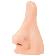 Rose gold diamond pave crescent moon stud worn in nostril piercing on silicone nose model