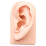 2mm CZ bezel flat back stud placed in helix piercing on silicone ear display model