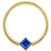 14k yellow gold fixed bead ring with blue princess-cut CZ in corner bezel mount, front view