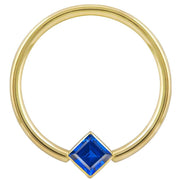 14k yellow gold fixed bead ring with blue princess-cut CZ in corner bezel mount, front view