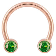 14k rose gold circular barbell with dual green CZ bezel ends, larger diameter front view