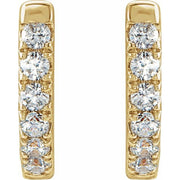 Close-up front view of 14k yellow gold diamond huggie hoops highlighting individual round diamond sparkle