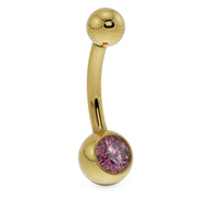 Side profile of 14K yellow gold navel ring with pink CZ round bezel setting