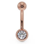 14K rose gold navel ring with clear CZ in round bezel ball, front view