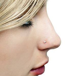 1.5mm diamond bezel nose stud shown on pierced nose, demonstrating subtle fit on model