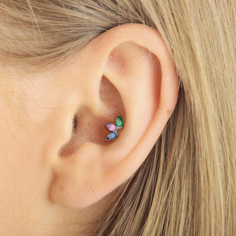 Triple pear gem flat back stud shown in a conch piercing on a model's ear