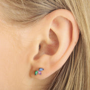 Pear gem trio flat back stud shown in a lobe piercing, demonstrating compact 6x10mm size