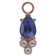 14K rose gold pear-cut blue sapphire piercing charm with three bezel-set diamond accents, front view