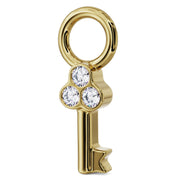 Angled side view of 14K yellow gold key charm showing depth of bezel diamond setting