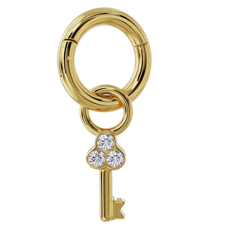 14K yellow gold diamond key charm attached to a clicker ring, showing how it connects