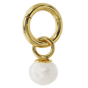 Pearl charm linked onto a gold clicker hoop, showing how charm attaches to piercing jewelry