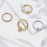 14K rose gold trinity diamond bar seam ring styled alongside three other gold diamond hoops