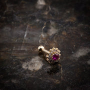 14K yellow gold gem cluster flower cartilage stud on dark stone surface, lifestyle shot