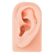 14k rose gold tiny heart cartilage stud shown in helix piercing on silicone ear model