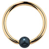 14K yellow gold captive bead ring with iridescent peacock pearl, front view
