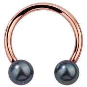 14K rose gold circular barbell with genuine peacock pearl ends, front view