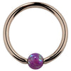 14K rose gold captive bead ring with purple opal bead, warm pink-tone hoop front view
