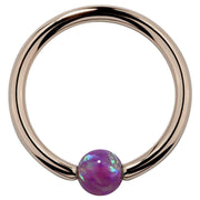14K rose gold captive bead ring with purple opal bead, warm pink-tone hoop front view