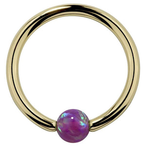 14K yellow gold captive bead ring with purple opal bead, front view on white background