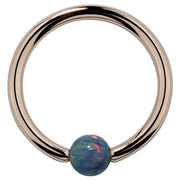 14K rose gold captive bead ring with teal simulated opal bead, front view on white background