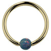 14K yellow gold captive bead ring with teal simulated opal bead, front view on white background