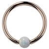 14K rose gold captive bead ring with white opal ball, front view showing warm pink-gold tone