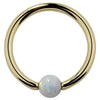 14K yellow gold captive bead ring with white opal ball, front view on white background