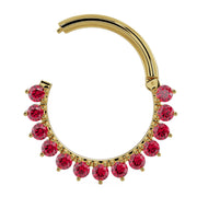 14K yellow gold garnet clicker ring shown open from a slight angle, highlighting the clicker clasp