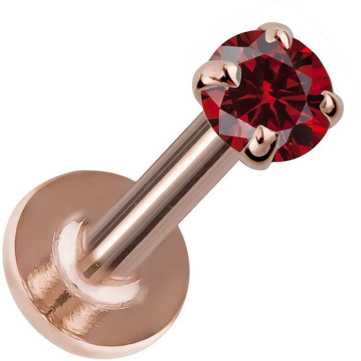 3mm garnet flat back labret in 14K rose gold, angled view showing red stone against warm rose-toned disc
