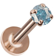2mm blue zircon flat back labret in 14K rose gold, angled view showing warm-toned post and disc