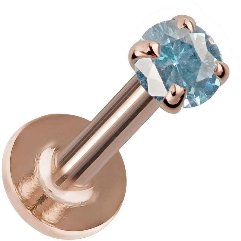 3mm blue zircon prong-set labret in 14K rose gold, angled view highlighting warm-toned flat back