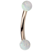 14K rose gold curved barbell with simulated opal balls showing warm pink-gold tone