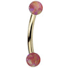 Pink simulated opal curved barbell in 14K yellow gold, side view showing dual opal balls
