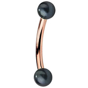 14K rose gold curved barbell with double peacock pearl ends, warm pink-gold bar detail