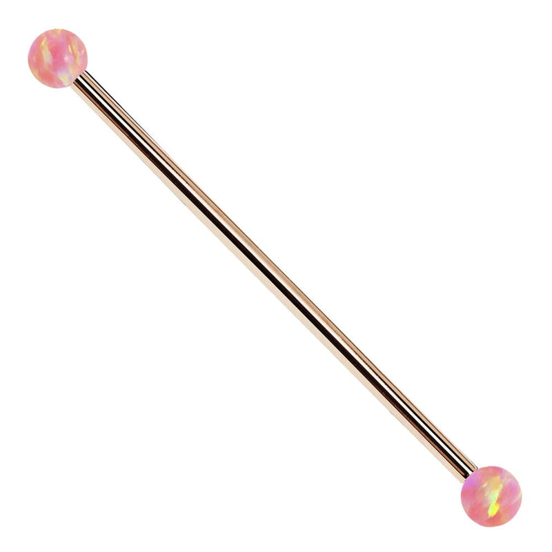 14k rose gold industrial barbell with pink synthetic opal ball ends, front view on white background