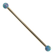 Teal opal 14k yellow gold industrial barbell with warm gold shaft and multicolor synthetic opal ball ends