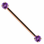 14k rose gold industrial barbell with dual purple round CZ gems in 4-prong settings, front view