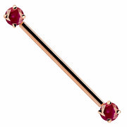 14k rose gold industrial barbell with dual red CZ prong-set ends, front view on white background