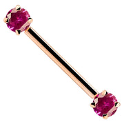 14k rose gold straight barbell with red prong-set CZ gemstones on white background