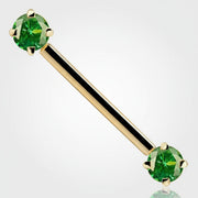 14k yellow gold straight barbell with dual prong-set round green CZ ends, angled view