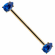 14k yellow gold industrial barbell with dual blue teardrop CZ gems in prong settings, diagonal view