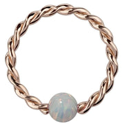 14K rose gold twisted captive bead ring with white opal bead, front view of braided hoop style