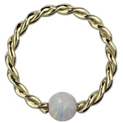 14K yellow gold twisted captive bead ring with white opal, front view showing rope-texture hoop