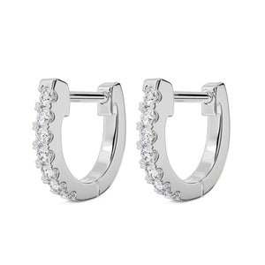 Pair of 14k white gold 10mm diamond huggie hoops with prong-set diamonds, angled view