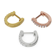 All three metal options of 13mm diamond huggie hoops side by side: yellow gold, rose gold, and white gold