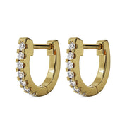 Pair of 14k yellow gold 10mm diamond huggie hoops with prong-set diamonds, angled view