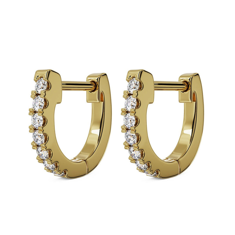 Pair of 14k yellow gold 10mm diamond huggie hoops with prong-set diamonds, angled view
