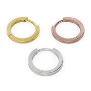 All three metal options of 10mm huggie hoops side by side: 14k yellow gold, rose gold, and white gold