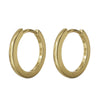 14k yellow gold huggie hoop earrings, pair shown at an angle highlighting polished finish